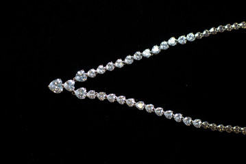 necklaces with precious stones on a black background