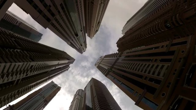 clouds float between the high-rise buildings in Dubai, UAE