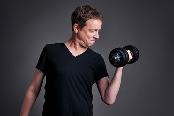 Fototapeta na wymiar Middle age man with weights 