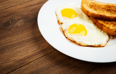 Traditional breakfast with fried eggs and toast