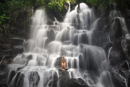 serenity and yoga practicing at waterfall Kanto Lampo, Bali,Indonesia