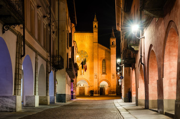 Piazza Risorgimento and via Cavour, main square of Alba (Piedmont, Italy) at night with the facade of Saint Lawrence cathedral