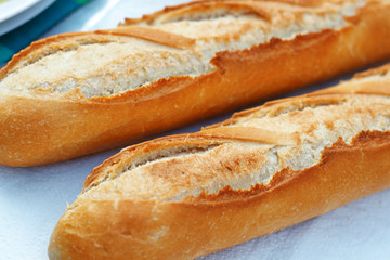 Two fresh French baguettes close up with shallow depth of field