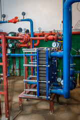 the pipeline in a boiler room, a set of curved pipes of blue color