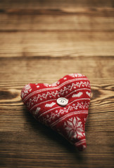 Rustic fabric heart on old wood background,