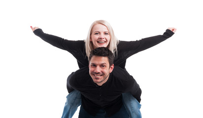 Young man giving piggyback ride to woman