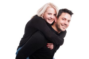 Happy portrait of man piggybacking his girlfriend