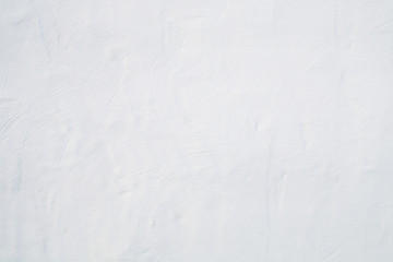 Big whitewashed white painted textured wall background.