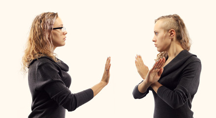 Self talk concept. Young woman talking to herself, showing gestures. Double portrait from two different side views.