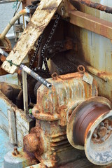 Fototapeta premium Rusty commercial fishing equipment including winch on board of fishing vessel.
