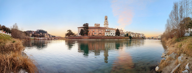 Fototapeta na wymiar historical quarter of Verona, panorama from river on ponte Pietra bridge and Duomo Cathedral at sunrise