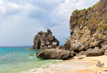 Fototapeta na wymiar Tropical beach with sand and rocks. White beach and turquoise blue water.