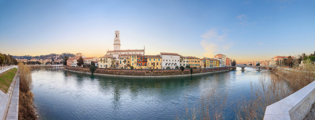 Fototapeta na wymiar historical quarter of Verona, panorama from river on Duomo Cathedral at sunrise