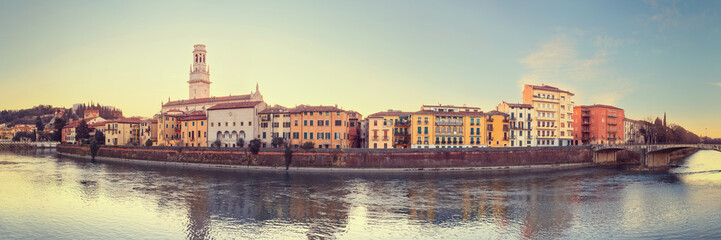 Fototapeta na wymiar historical quarter of Verona, panorama from river on Duomo Cathedral at sunrise. Creative toning effect