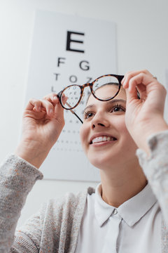 Happy woman trying her new glasses