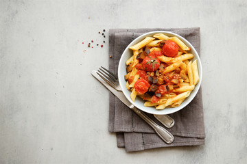 Penne pasta with tomato sauce, garlic and eggplant 
