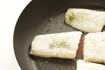 Thymus and flat fish on frying pan