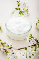 Obraz na płótnie Canvas Face cream with spring flowers on white background