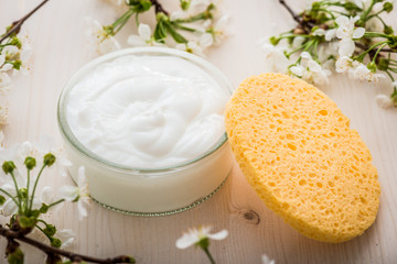 Obraz na płótnie Canvas Face cream with spring flowers on white background