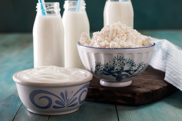 Dairy products on wooden table over blue background