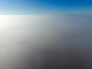 In the skies above the fog. Sunrise over the fog. Clouds near the ground