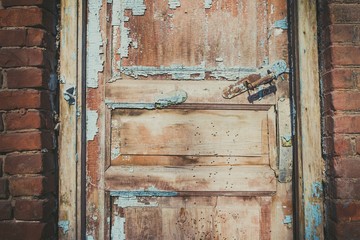 Old abandoned door, detail of a door of a house in ruins. Stock image.