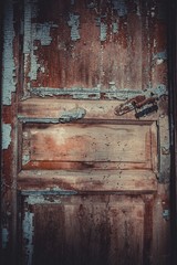 Old abandoned door, detail of a door of a house in ruins. Stock image.