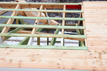Fototapeta na wymiar The wooden structure of the building. Wooden frame building. Wooden roof construction.