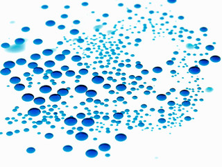 Bubbles of paint on white background, abstract pattern of blue ink. Random drop.