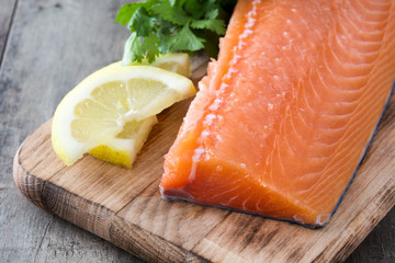 Raw salmon fillet on wooden background
