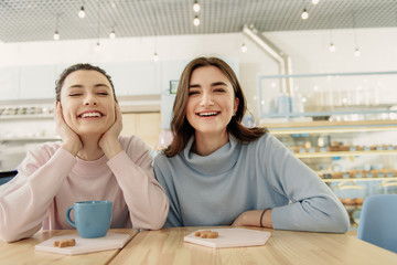 Happy laughing women in cafeteria