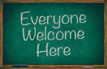Everyone welcome here written on green chalkboard in wooden frame with wiper and chalk, retro effect