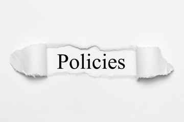 Policies on white torn paper