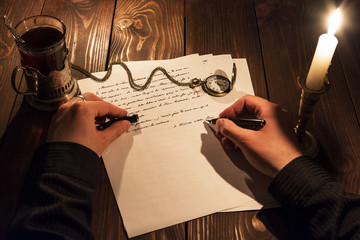 The man behind the table holding the fountain pen