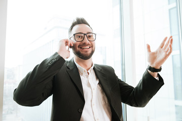 Happy Bearded business man talking on phone