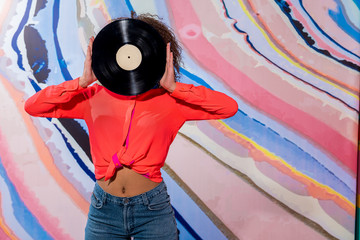 Woman keeping gramophone record in hand
