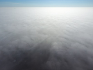 In the skies above the fog. Sunrise over the fog. Clouds near the ground