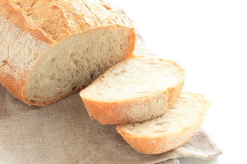 Sliced French bread on linen cloth