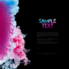 Color splashes of ink isolated on black background. Abstract paint in water motion. Swirling...