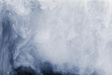 Abstract cloud pattern of white smoke on a black background.