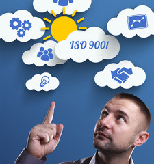 Business, Technology, Internet and marketing. Young businessman thinking about: ISO 9001