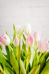 bouquet of white and pink tulips on a light background