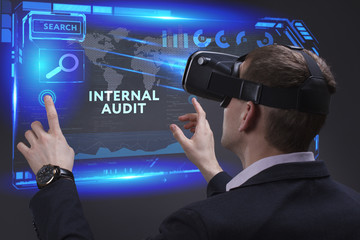 Business, Technology, Internet and network concept. Young businessman working on a virtual screen of the future and sees the inscription: Internal audit