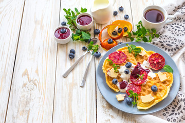 Coffee and Belgium waffles with blueberry. Breakfast concept.