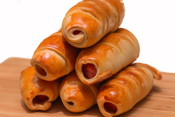 Sausage rolls, cooking food at home. Golden color crust.