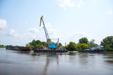 The cargo barge floats on the river