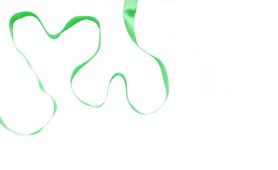 Two hearts made from green ribbon on white background . Saint patrick's day