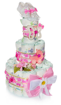 Birthday diapers cake decorated with bow, children's shoes, cart, butterfly, beads.