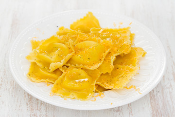 boiled ravioli on wooden background