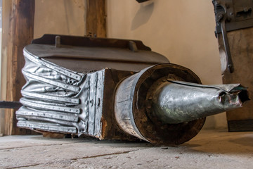 Large antique bellows on floor